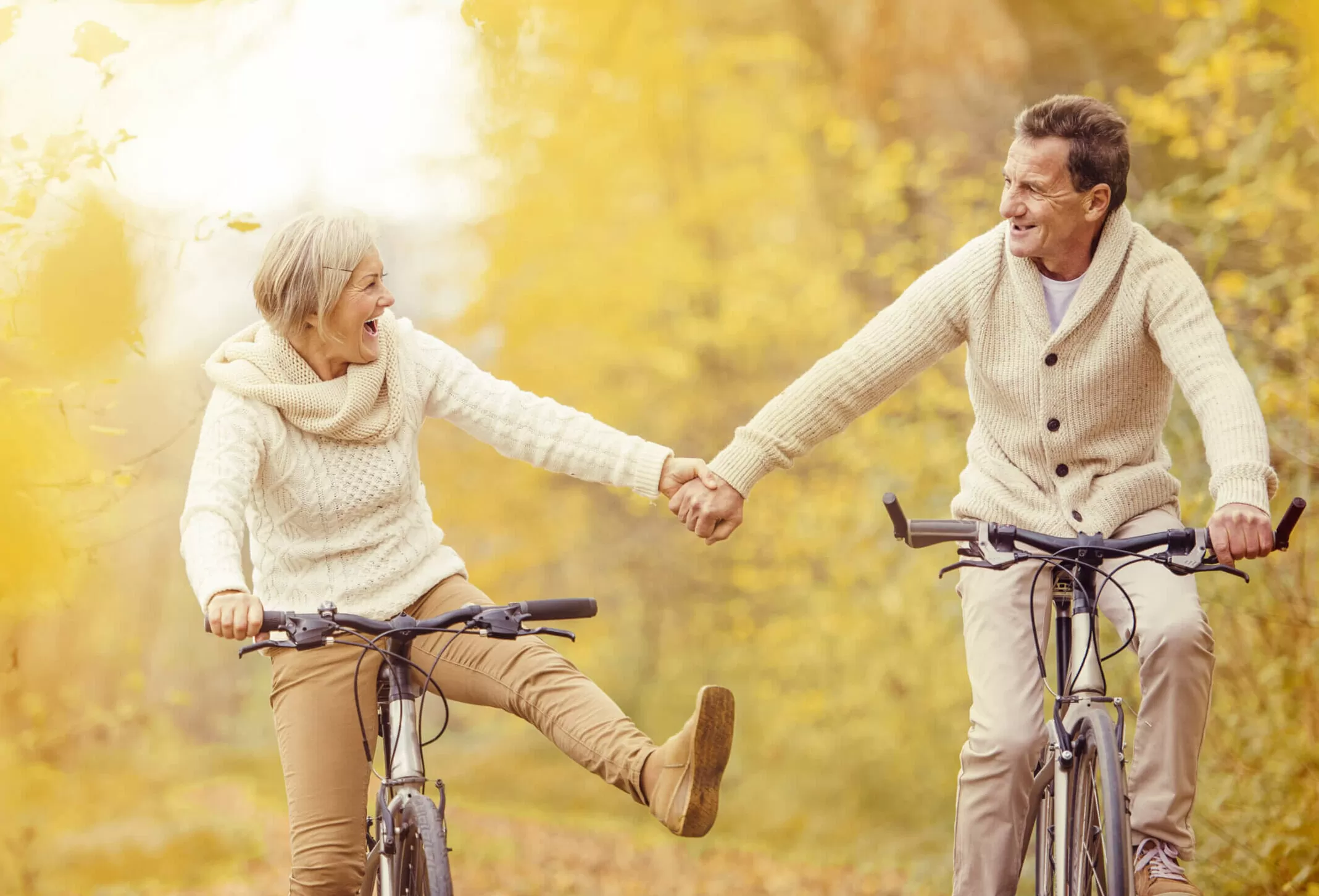 A happy couple riding bicycle